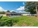 Lush backyard showcases a screened-in pool area, offering a private oasis for relaxation and leisure at 3881 Se 61St Pl, Ocala, FL 34480