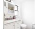 Bright bathroom featuring a white vanity with brushed nickel faucet and modern toilet at 3881 Se 61St Pl, Ocala, FL 34480