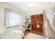 Bedroom featuring wood-look floors, a hanging chair and a large closet with louvered doors at 3881 Se 61St Pl, Ocala, FL 34480