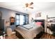 Comfortable bedroom with wood-look floors, a ceiling fan, and wall decorations at 3881 Se 61St Pl, Ocala, FL 34480