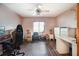 Spacious bonus room featuring modern ceiling fan, wood-look flooring, and natural light at 3881 Se 61St Pl, Ocala, FL 34480
