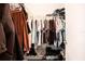 Walk-in closet with ample storage space, featuring racks, shelves, and hanging rods at 3881 Se 61St Pl, Ocala, FL 34480