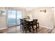 Dining room with chandelier, dark wood table set, and curtains over sliding glass door at 3881 Se 61St Pl, Ocala, FL 34480