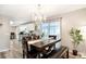 Bright dining room with chandelier, table, and chairs adjacent to the kitchen area at 3881 Se 61St Pl, Ocala, FL 34480