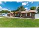 Charming brick home with a well-maintained lawn, covered porch, and attached garage at 3881 Se 61St Pl, Ocala, FL 34480