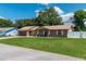 Charming brick home with a well-maintained lawn, covered porch, and attached garage at 3881 Se 61St Pl, Ocala, FL 34480