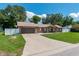 Beautiful brick home with an attached two-car garage and a spacious driveway at 3881 Se 61St Pl, Ocala, FL 34480