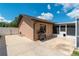Exterior view of a home with a barbecue, gated area, and screened in porch at 3881 Se 61St Pl, Ocala, FL 34480