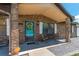 Inviting front porch with seating area and a vibrant wreath on the front door at 3881 Se 61St Pl, Ocala, FL 34480
