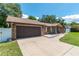 Attached garage, ample parking on a large driveway, and a well manicured front yard at 3881 Se 61St Pl, Ocala, FL 34480