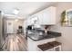 Eat-in kitchen with white cabinetry, stainless steel appliances, and stone countertops at 3881 Se 61St Pl, Ocala, FL 34480