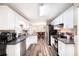 Bright kitchen with white cabinetry, stainless steel appliances, and wood-look flooring at 3881 Se 61St Pl, Ocala, FL 34480