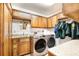Laundry room featuring modern washer and dryer, wood cabinets and countertop space at 3881 Se 61St Pl, Ocala, FL 34480