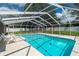 Beautiful screened-in pool with lounge chairs and spacious seating areas, perfect for relaxing or entertaining at 3881 Se 61St Pl, Ocala, FL 34480