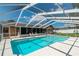 Relax in this screened-in pool featuring a clear view of the backyard and access to the lanai at 3881 Se 61St Pl, Ocala, FL 34480