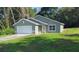 Charming single-story home featuring an attached two-car garage and a well-maintained front yard at 4121 Se 138Th Pl, Summerfield, FL 34491