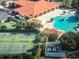 Aerial view of community center and amenities, including pools and tennis courts at 5009 Neptune Cir, Oxford, FL 34484