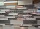Close-up of a stylish and modern tiled backsplash at 5009 Neptune Cir, Oxford, FL 34484