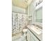 Bright bathroom featuring a sink, toilet, shower and decorative Paris themed shower curtain at 5009 Neptune Cir, Oxford, FL 34484