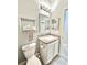 This bathroom features a mirrored vanity, toilet and towel rack at 5009 Neptune Cir, Oxford, FL 34484