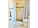 Tiled shower with a rainfall shower head, accent tiling and a built-in seat at 5009 Neptune Cir, Oxford, FL 34484