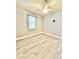 Cozy bedroom features tile floors, a ceiling fan and a bright window at 5009 Neptune Cir, Oxford, FL 34484