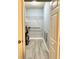 Walk in closet showcasing metal shelving and gray tile flooring at 5009 Neptune Cir, Oxford, FL 34484