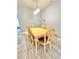 Bright dining area features wood table with six chairs and modern chandelier lighting at 5009 Neptune Cir, Oxford, FL 34484