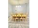 Bright dining area features wood table with six chairs and modern chandelier lighting at 5009 Neptune Cir, Oxford, FL 34484