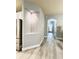 Hallway area shows niche, updated flooring, and access to kitchen at 5009 Neptune Cir, Oxford, FL 34484