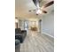 Spacious living room and dining room featuring wood-look tile flooring and modern lighting at 5009 Neptune Cir, Oxford, FL 34484