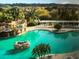Resort style pool with rock waterfall features and lounge chairs at 5009 Neptune Cir, Oxford, FL 34484