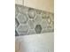 Close up of tiled shower accent with gray tone hexagon shapes at 5009 Neptune Cir, Oxford, FL 34484