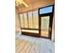 Bright sunroom with sliding doors, outdoor views, ceiling fan, and tile flooring at 5009 Neptune Cir, Oxford, FL 34484