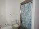 Bathroom featuring a toilet, and shower with curtain at 5391 Nw 19Th Pl, Ocala, FL 34482