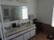 Practical bathroom with a double sink vanity and a glass block window allowing for ample light at 5391 Nw 19Th Pl, Ocala, FL 34482