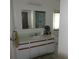 Bright bathroom featuring a vanity with a sink and a mirror at 5391 Nw 19Th Pl, Ocala, FL 34482