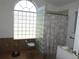 Bright bathroom with unique glass block window and walk in shower, offering convenience and natural light at 5391 Nw 19Th Pl, Ocala, FL 34482