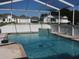 Relaxing screened-in pool area features a sparkling pool with an attached spa, perfect for outdoor enjoyment at 5391 Nw 19Th Pl, Ocala, FL 34482