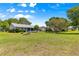 Expansive backyard featuring a well-maintained lawn, mature trees, and a screened-in lanai at 8532 Sw 65Th Court Rd, Ocala, FL 34476