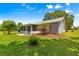 A lush, green backyard with a well-maintained lawn and a view of the screened in patio at 8532 Sw 65Th Court Rd, Ocala, FL 34476