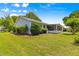 Well-manicured backyard features an expansive lawn, mature trees and a screened-in lanai at 8532 Sw 65Th Court Rd, Ocala, FL 34476