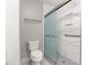 Bathroom featuring a toilet and tiled shower with modern fixtures and grab bars at 8532 Sw 65Th Court Rd, Ocala, FL 34476