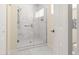 Modern bathroom featuring a glass enclosed shower with white marble surround and grab bar at 8532 Sw 65Th Court Rd, Ocala, FL 34476