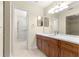 Updated bathroom with dual mirrors, wood cabinets, and tiled walk-in shower at 8532 Sw 65Th Court Rd, Ocala, FL 34476