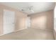Bedroom with neutral carpet, ceiling fan, and two closets at 8532 Sw 65Th Court Rd, Ocala, FL 34476