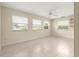 Bedroom with tile floors, ceiling fan, and a large window at 8532 Sw 65Th Court Rd, Ocala, FL 34476