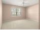 Bedroom with neutral carpet, ceiling fan, and a window at 8532 Sw 65Th Court Rd, Ocala, FL 34476