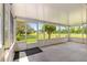 View of screened-in lanai with a large tree outside the clear pane windows at 8532 Sw 65Th Court Rd, Ocala, FL 34476