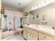 Bathroom featuring a vanity, toilet, and tub with a unique fashion-themed shower curtain at 8710 Sw 91St St # E, Ocala, FL 34481